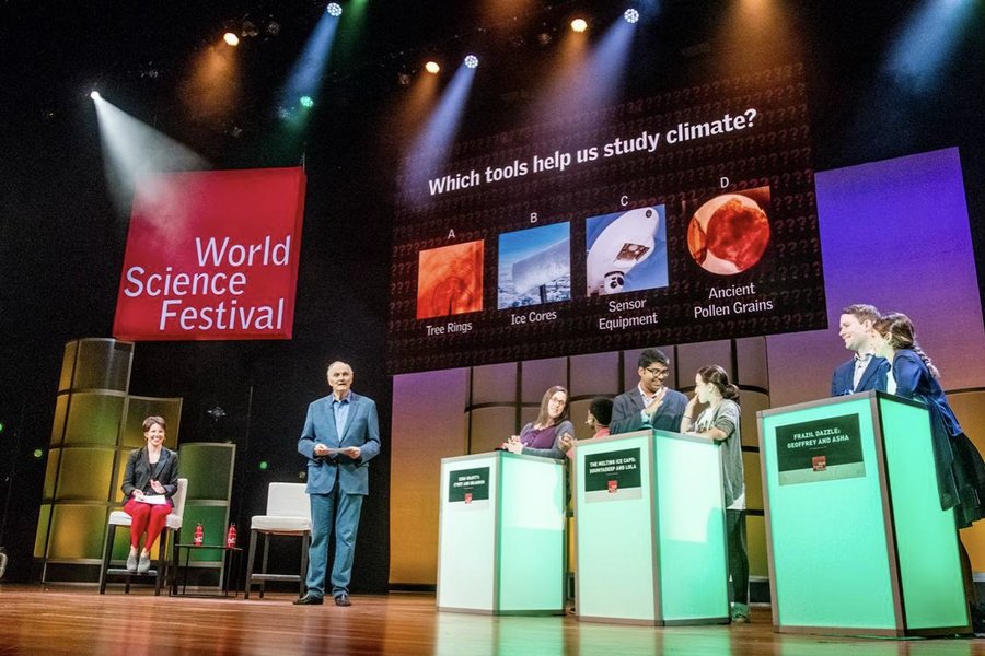 Bernadette Woods Placky on stage at the World Science Festival during a climate quiz with student teams