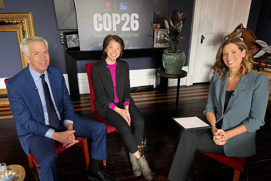Bernadette Woods Placky seated for a Weather Channel COP26 interview with two other panellists